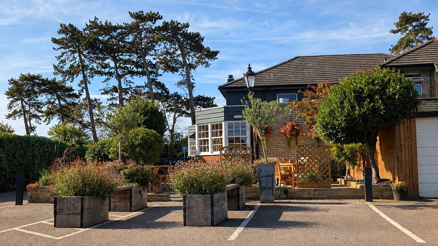 Timber planters of flowering perennials greening the car park at The Builders Arms